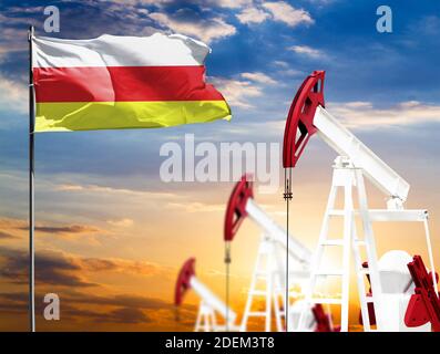 Il petrolio si aggraffa sullo sfondo del cielo colorato e di un flagpole con la bandiera dell'Ossezia del Sud. Il concetto di produzione di petrolio, minerali, sviluppo Foto Stock