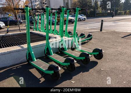 BUCAREST, ROMANIA - 26 novembre 2020: Scooter a bullone verde in affitto allineati in città in attesa di essere affittati via Bolt app Foto Stock