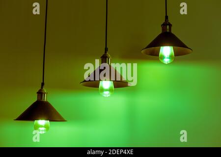 Tre lampade con lampadine a incandescenza vintage in luce verde Foto Stock