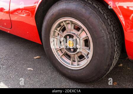 Primo piano della ruota in lega e dello pneumatico su Una Ferrari Dino 246 GT rossa degli anni '70 Foto Stock