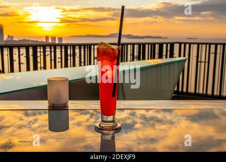 Goditi un cocktail Singapore Sling in Thailandia, nel sud-est asiatico Foto Stock