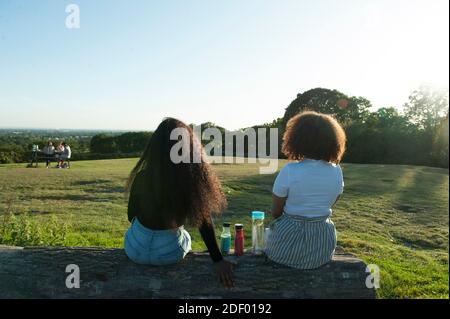 Le persone che godono il sole serale al Harrow View Point Foto Stock