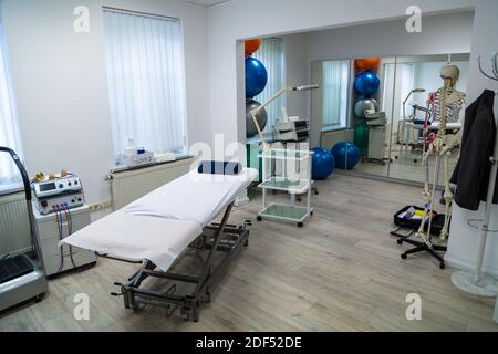Cabina medica per fisioterapeuta con lettino massaggiante e scheletro Foto Stock
