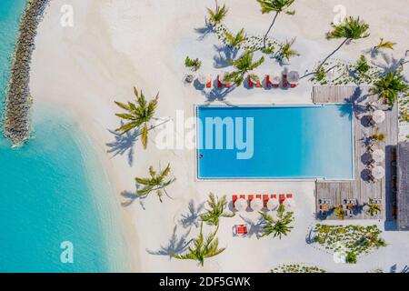 Vista aerea del bellissimo paesaggio estivo dell'hotel riva del mare, costa, acque azzurre del mare, spiaggia di sabbia, palme piscina infinity, sedie, letti. Resort di lusso Foto Stock