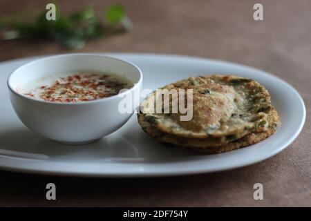 Un sano pane piatto indiano chiamato Methi poori fatto di farina integrale mescolata con foglie di Fenugreek, buon sapore se servito con cagliata mescolata con indiana Foto Stock