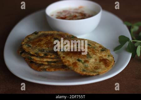 Un sano pane piatto indiano chiamato Methi poori fatto di farina integrale mescolata con foglie di Fenugreek, buon sapore se servito con cagliata mescolata con indiana Foto Stock