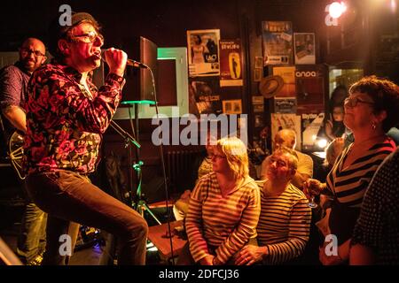 CANTANTE DEL GRUPPO LES MEGOTS DI FRONTE AD UN PUBBLICO ATTENTO, CAFE-CONCERTO LA CLASSE, SAINT-HILAIRE-SUR-RISLE, ORNE, NORMANDIA, FRANCIA Foto Stock