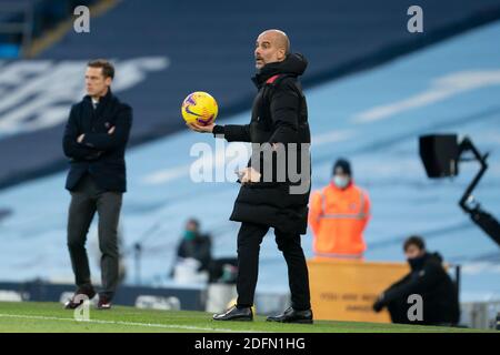 Manchester, Regno Unito. 6 Dicembre 2020. Il capo allenatore di Manchester City Pep Guardiola tiene la palla durante la partita della Premier League tra Manchester City e Fulham a Manchester, Gran Bretagna, il 5 dicembre 2020. Credit: Xinhua/Alamy Live News Foto Stock