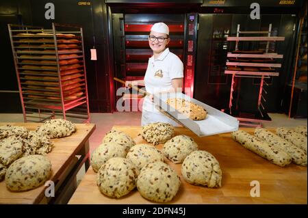 Dresda, Germania. 04 dicembre 2020. Johanna Meitzner, 26à Dresden Stollen Girl, ospita uno Stollen appena sfornato presso la panetteria Morenz. A causa delle misure di protezione corona, l'apprendista fornaio di 21 anni non può, come i suoi predecessori, svolgere il suo ruolo di ambasciatore dello Stollen di Natale di Dresda. Credit: Sebastian Kahnert/dpa-Zentralbild/dpa/Alamy Live News Foto Stock