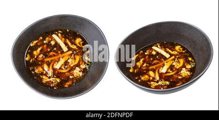 Set di zuppa cinese acida e piccante con gamberi e pollo (brodo con pollo, gamberi, tofu, bambù, funghi, uova e salsa di soia scura) in nero Foto Stock