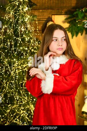 Festeggia il nuovo anno vicino all'albero di natale. Noleggio di costumi per il carnevale. Felice infanzia. Bambina festeggia il natale. Noleggio accessori per le vacanze. Servizi di noleggio decorazioni. Concetto di vacanza invernale. Foto Stock