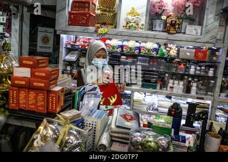 Medan, Sumatera del Nord, Indonesia. 7 Dic 2020. Un operaio prepara un cappello di Babbo Natale, che sarà venduto al mercatino di decorazione del giorno di Natale in preparazione al Natale a Medan. Credit: Kartik Byma/SOPA Images/ZUMA Wire/Alamy Live News Foto Stock