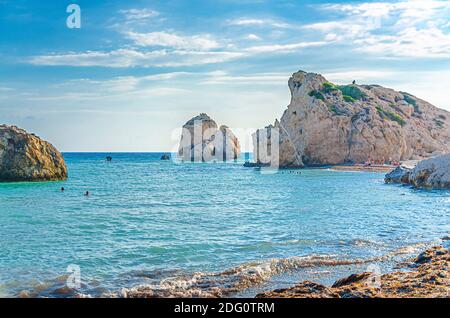 Aphrodite Beach con rocce di pietra nella baia di Aphrodite di acqua di mare mediterranea, cielo blu in background giorno di sole, Petra tu Romiou, Cipro Foto Stock