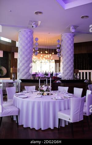 Il matrimonio impostazione tabella per gli sposi è decorata con fiori freschi di garofano, rosa, Anthurium e foglie di eucalipto. Candelieri in argento, Foto Stock