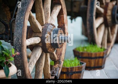 Ruota di un vecchio carrello di legno come elemento decorativo outdors Foto Stock