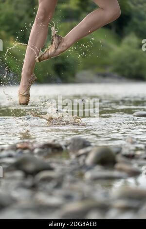 Ballerina che salta nel fiume Foto Stock