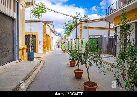 Nicosia, Cipro, 24 settembre 2017: Strada della città con case bianche edifici e alberi in pentole su strada nel centro storico vicino al contr passaporto di frontiera Foto Stock