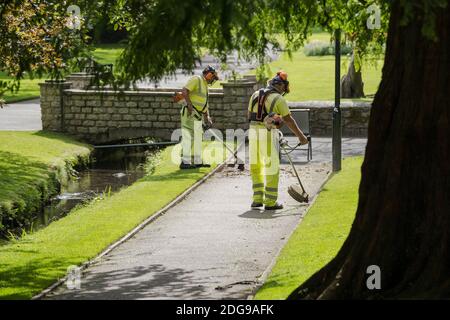 Lavoratori Cormac striping erba in Trenance Gardens a Newquay in Cornovaglia. Foto Stock