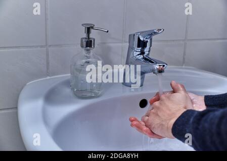 Primo piano di una persona che si lava le mani. Persona che lava le mani con sapone. Foto Stock