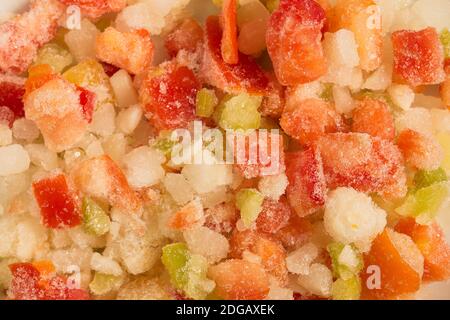 Soffriggere le verdure crude e surgelate colorate con consistenza e glassa come sfondo. Cibo vegetariano. Foto Stock