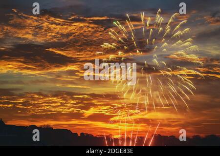 Splendido spettacolo di fuochi d'artificio per festeggiare il suggestivo cielo del tramonto. Foto Stock