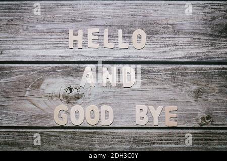 Ciao e arrivederci lettere di legno non scritto a strisce sfondo di legno Foto Stock