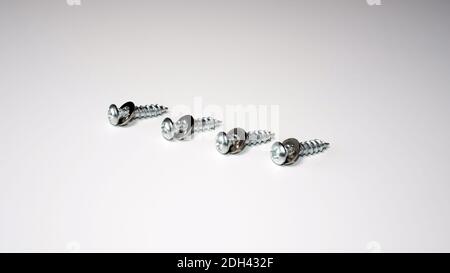 Self-tapping screws with washers on a white background. Stock Photo