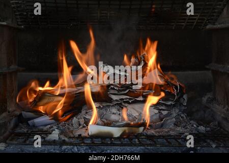 Masterizzazione di documenti cartacei. Fiamme e carta bruciata. Buon esempio di distruggere la prova bruciandola. Ceneri lasciate dietro. Foto Stock