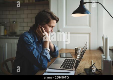 Donna designer che lavora fino a tardi in ufficio a casa Foto Stock