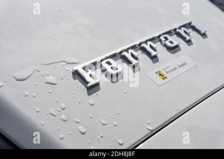 Close up detail of the company logo badge with water splashes on the rear of a white Ferrari F8 Spider convertible sports car Stock Photo