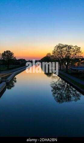 Suggestivo e affascinante cielo colorato al tramonto su un canale Foto Stock