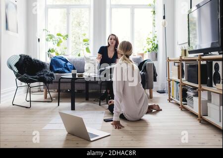 I colleghi discutono mentre sono seduti in salotto Foto Stock