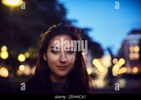 Primo piano ritratto di donna in città di notte Foto Stock