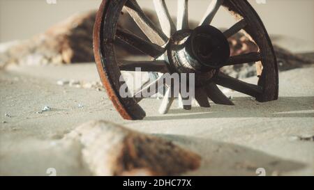 Grande ruota di legno nella sabbia Foto Stock