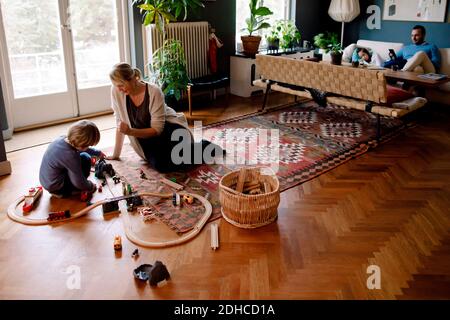 Madre e figlia giocano con il treno in soggiorno a casa Foto Stock