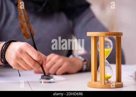 Giovane scrittore maschile nel concetto di gestione del tempo Foto Stock