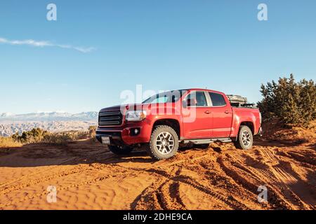 camion del pick-up rosso con tenda in sabbia morbida vicino Moab, Utah Foto Stock