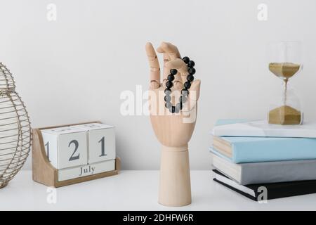 Mano in legno con braccialetti sul tavolo Foto Stock