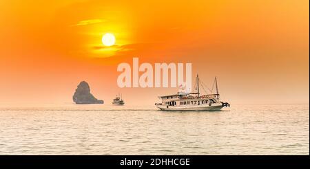 Dreamy sunset among the rocks of Halong Bay, Vietnam, This is the UNESCO World Heritage Site, it is a beautiful natural wonder in northern Vietnam Stock Photo