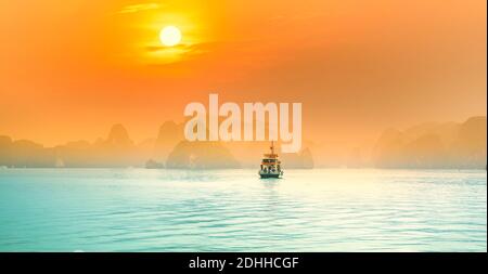 Dreamy sunset among the rocks of Halong Bay, Vietnam, This is the UNESCO World Heritage Site, it is a beautiful natural wonder in northern Vietnam Stock Photo