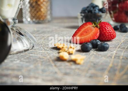 Gelato con fragole e mirtilli in un bicchiere alto Foto Stock