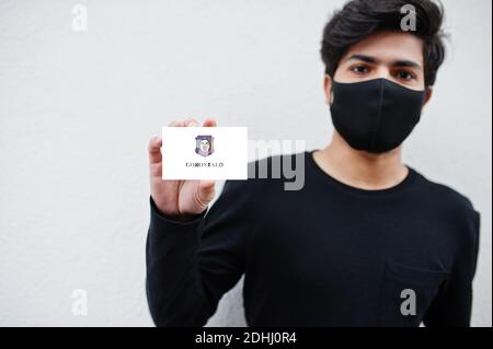 Indonesiano uomo indossare tutto nero con maschera faccia tenere Gorontalo bandiera in mano isolato su sfondo bianco. Province dell'Indonesia coronavirus concetto. Foto Stock