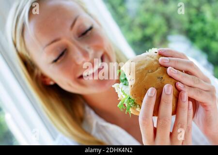 Donna di mangiare un panino Foto Stock