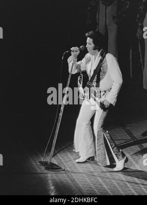 Elvis Presley si esibisce presso il Richfield Coliseum vicino a Cleveland il 10 luglio 1975. Indossa il suo jumpsuit Black Pheonix in questa performance. Ernie Mastroianni foto Foto Stock