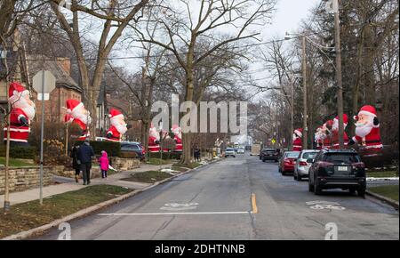 Toronto, Canada. 11 Dicembre 2020. Le clausole di Santa gonfiabili di dimensioni giganti sono viste su Inglewood Drive a Toronto, Canada, 11 dicembre 2020. A partire dal 2013, decine di clausole di Santa gonfiabili alte 14 piedi si estendono lungo Inglewood Drive a Toronto durante la stagione delle vacanze, attirando molti visitatori. Credit: Zou Zheng/Xinhua/Alamy Live News Foto Stock