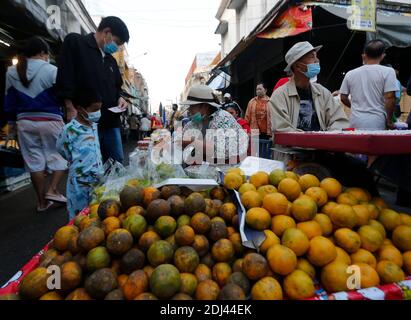 Un venditore di frutta indossa una maschera facciale come misura preventiva contro il coronavirus, come lei serve i clienti in un mercato fresco nella provincia di Phitsanulok.Ministero della Salute Thailandia ha registrato un totale di 4,209 infezioni, 60 morti e 3,923 recuperati dall'inizio dell'epidemia. Foto Stock