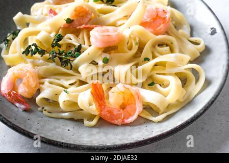 Pasta di fetticcine di gamberetti. Pasta italiana con gamberi e crema salsa alfredo, primo piano. Foto Stock