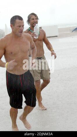 Matthew McConaughey e il compagno di esercizi Lance Armstrong vanno a fare uno scherzo durante una pesante tempesta di pioggia a Miami Beach, FL 8/8/06 Foto Stock