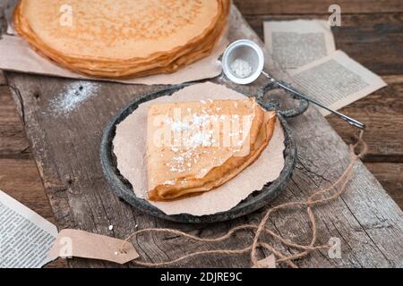 Frittelle su vecchie tavole di legno e foglietti. Foto Stock