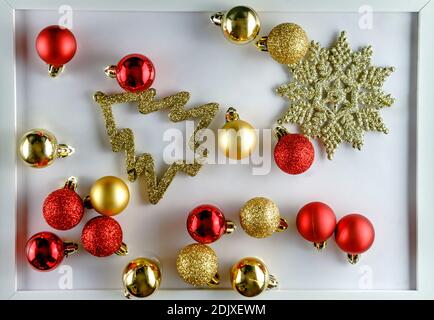 High angle view of red and golden Christmas decoration on white background Foto Stock